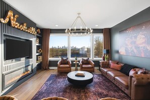 TV, fireplace, books - City View Home with HotTub, Rooftop, Arcade Game, and Parking (Nashville)