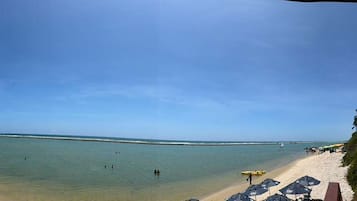 On the beach, beach umbrellas, beach towels, beach bar