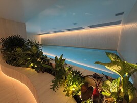 Una piscina techada, sillones reclinables de piscina