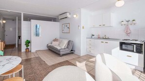 A modern apartment with a living room, kitchen, and dining area. - Boho Oceanview Getaway (Gold Coast)