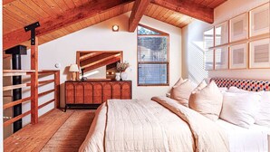 A bedroom with a wooden ceiling, a bed with white bedding, a dresser, a mirror, and a window with blinds. - Cozy 1BD & Loft for 4 Near Community Pool & Trails (Sea Ranch)
