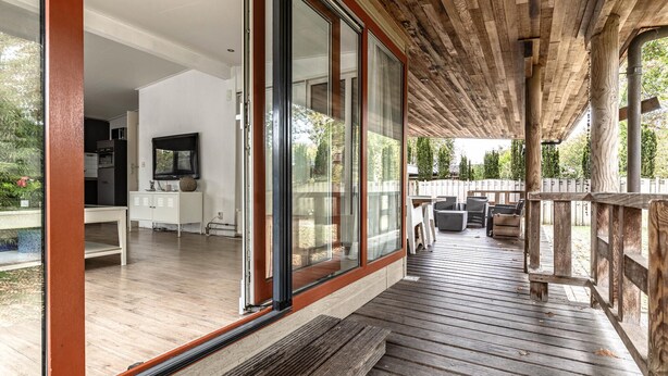 A spacious indoor area with a large sliding glass door leading to an outdoor deck. - Lovely home in Erm with WiFi (Erm)
