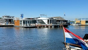 A marina with several houseboats docked.