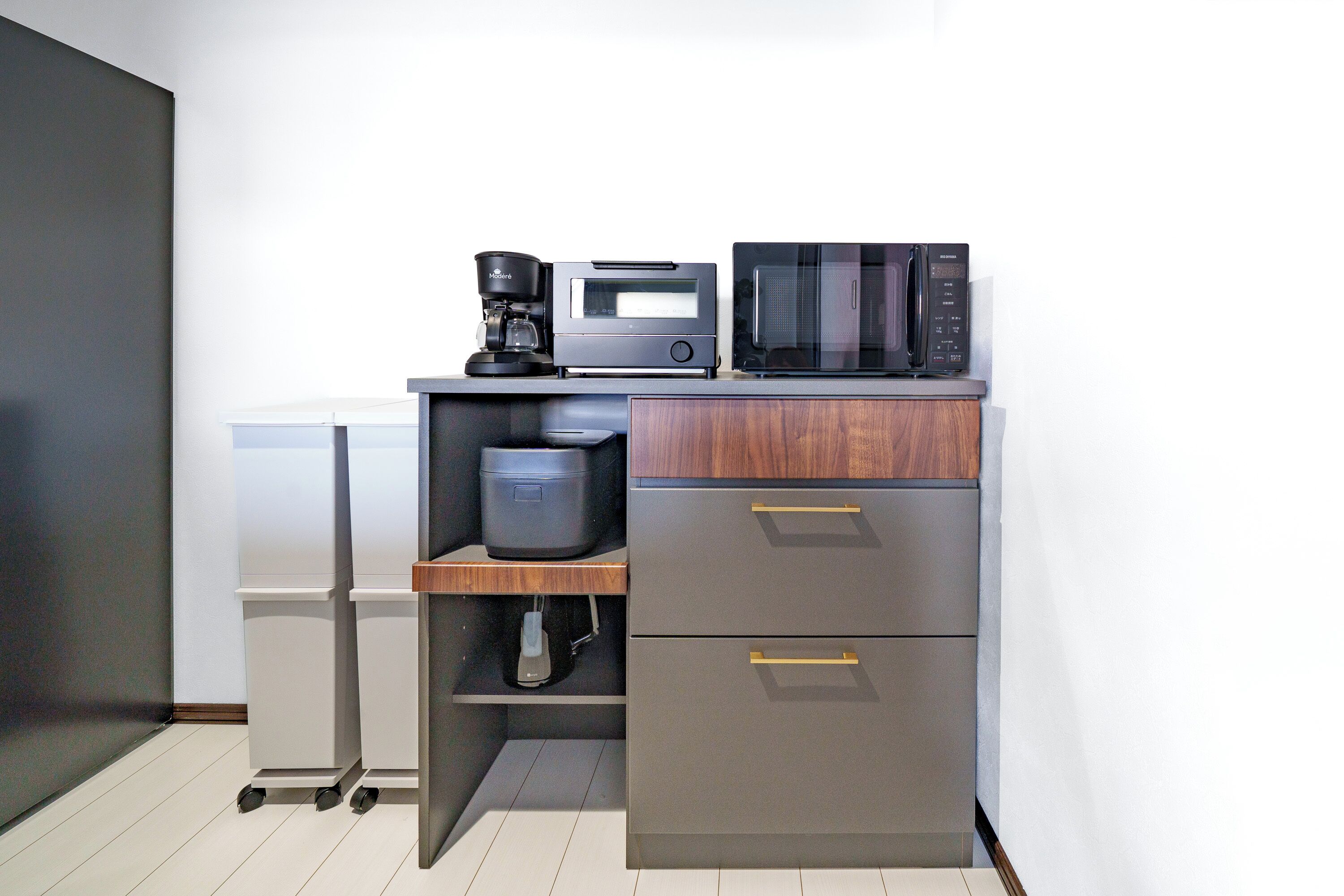 A compact kitchenette with a coffee maker, microwave, and a small refrigerator.