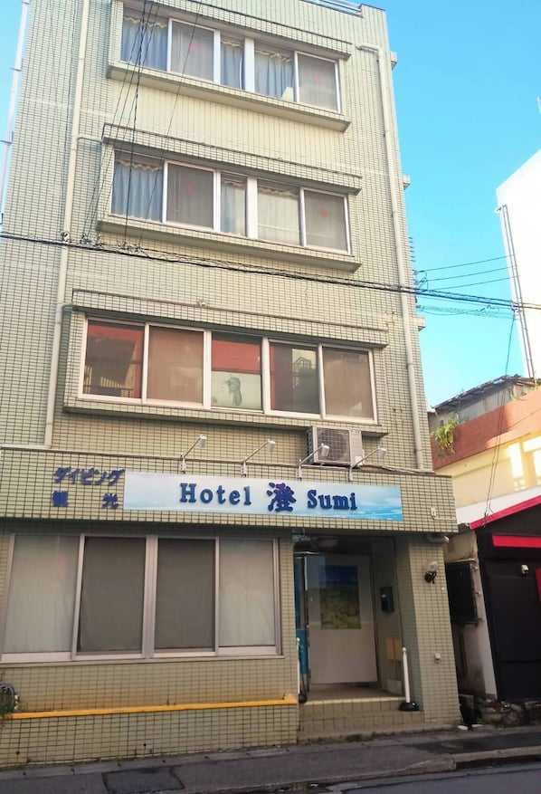 A multi-story building with a sign for 'Hotel Sumi' on the ground floor. - HotelSumi (Naha)