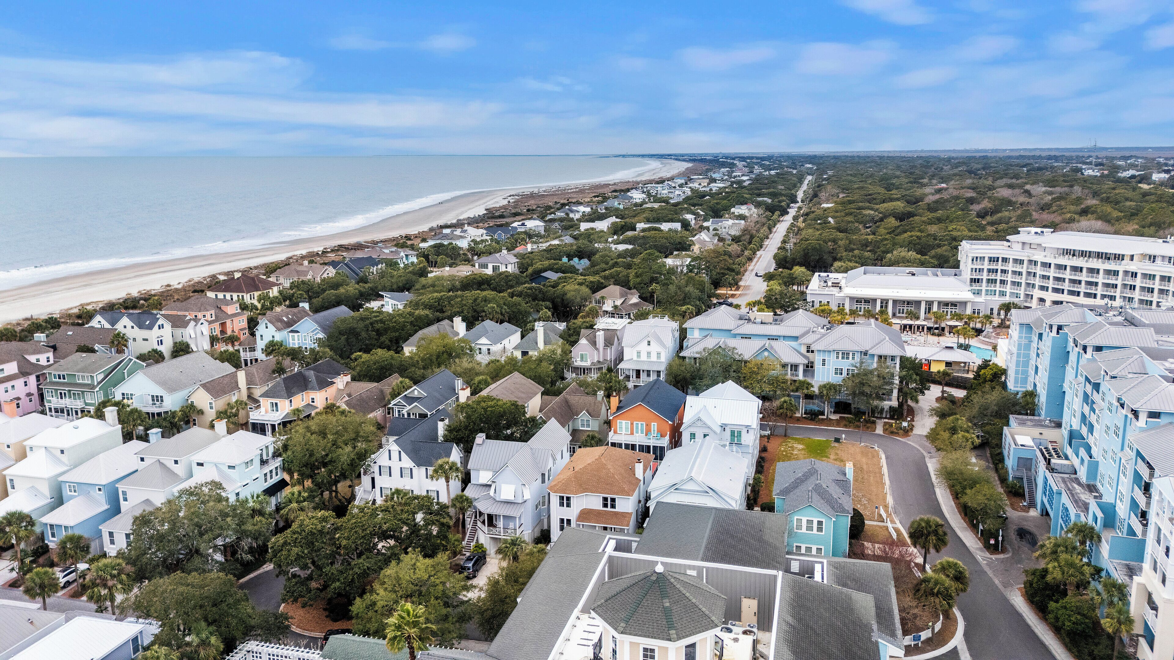 A coastal residential area with houses and a large hotel.