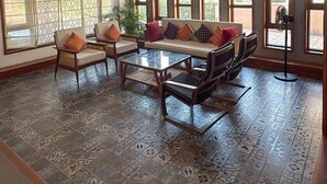 A spacious room with a high ceiling, large windows, and patterned floor tiles. - Lahari by Hireavilla - Chic 4BR Beachfront Villa (Udupi)