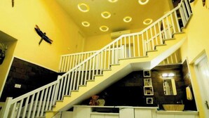 A staircase with white railings leading to a landing.