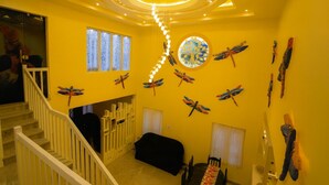 A staircase with a white railing leading to a landing.