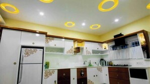 A kitchen with white cabinets, decorative patterns, and a built-in oven.
