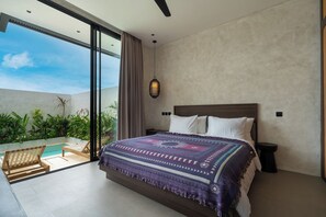 A bedroom with a large bed, a view of a swimming pool, and a ceiling fan. - Villa Fresko 5 by Alfred in Bali (Munggu)