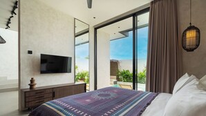 A bedroom with a large bed, a TV on the wall, and a view of the outdoors. - Villa Fresko 5 by Alfred in Bali (Munggu)