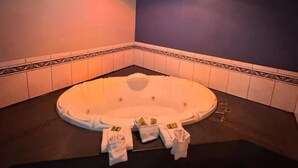 A bathroom with a freestanding bathtub, a shower, and a toilet. - Sunset inn &Suites (Gardena)
