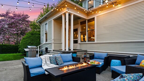 A patio with outdoor furniture, a fire feature, and string lights. - Gorgeous 1902 Craftsman-EV Charger-Lush Grounds-Walk to Main Street-Dogs OK (Walla Walla)