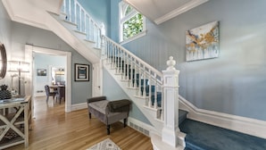 A staircase with white balusters, a wooden floor, and a blue wall. - Gorgeous 1902 Craftsman-EV Charger-Lush Grounds-Walk to Main Street-Dogs OK (Walla Walla)