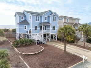 A two-story house with a balcony, a small deck, and a number 211 mailbox. - Hobbs Realty - The Roost: Spacious 5-Bedroom, Private Pool, Elevator, $250 Beach Gear Credits (Holden Beach)