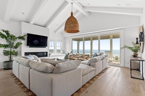 TV, fireplace - Villa Kai | Oceanfront Luxury w/ Pool, Fire Pit, Elevator, Cabana & $250 Beach Gear Credit (Holden Beach)
