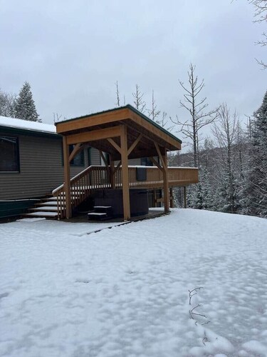 Ski getaway with hill view and hot tub- Upper Unit