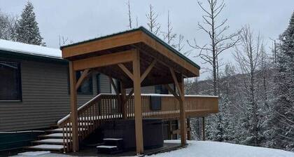 Ski getaway with hill view and hot tub- Upper Unit