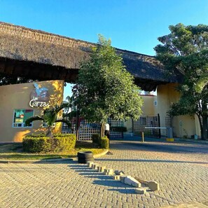 A building with a thatched roof and a sign reading "Las Garzas." - Tropical apartment with pool (Acapulco de Juárez)