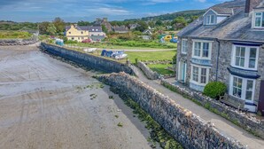 A coastal town with stone walls, a sandy beach, and traditional houses. - Craig y Mor, Holiday Cottage Newport, Sleeps 10, 5 bedrooms,  bathrooms (Newport)