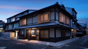 A traditional Japanese building with a modern extension, featuring a well-lit entrance and a clear view of the street. - Rinn Kyoto Ebisunocho (Kyoto)