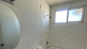 A small, compact bathroom with a toilet, sink, and bathtub.