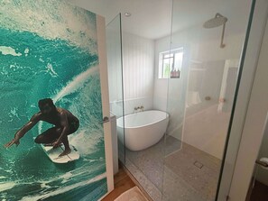 A bathroom with a glass-enclosed shower, a freestanding bathtub, and a mural of a surfer on a wave. - Spacious Bilinga Beach Stay | Sleeps 6 + Sauna, Unit 5 (Bilinga)