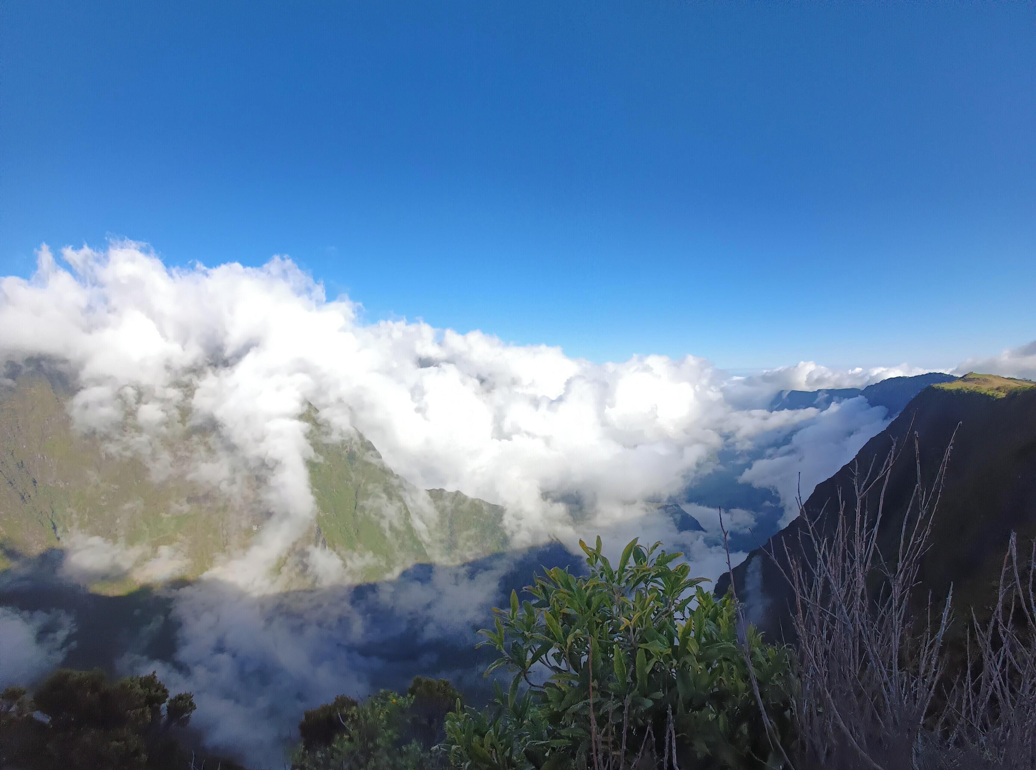 A mountainous landscape with clouds below the peaks.