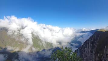 A mountainous landscape with clouds below the peaks.