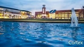 A modern building with a water feature in front. - New, Walk to Beach, Game Room, Fire Pit, King Beds (Norfolk)