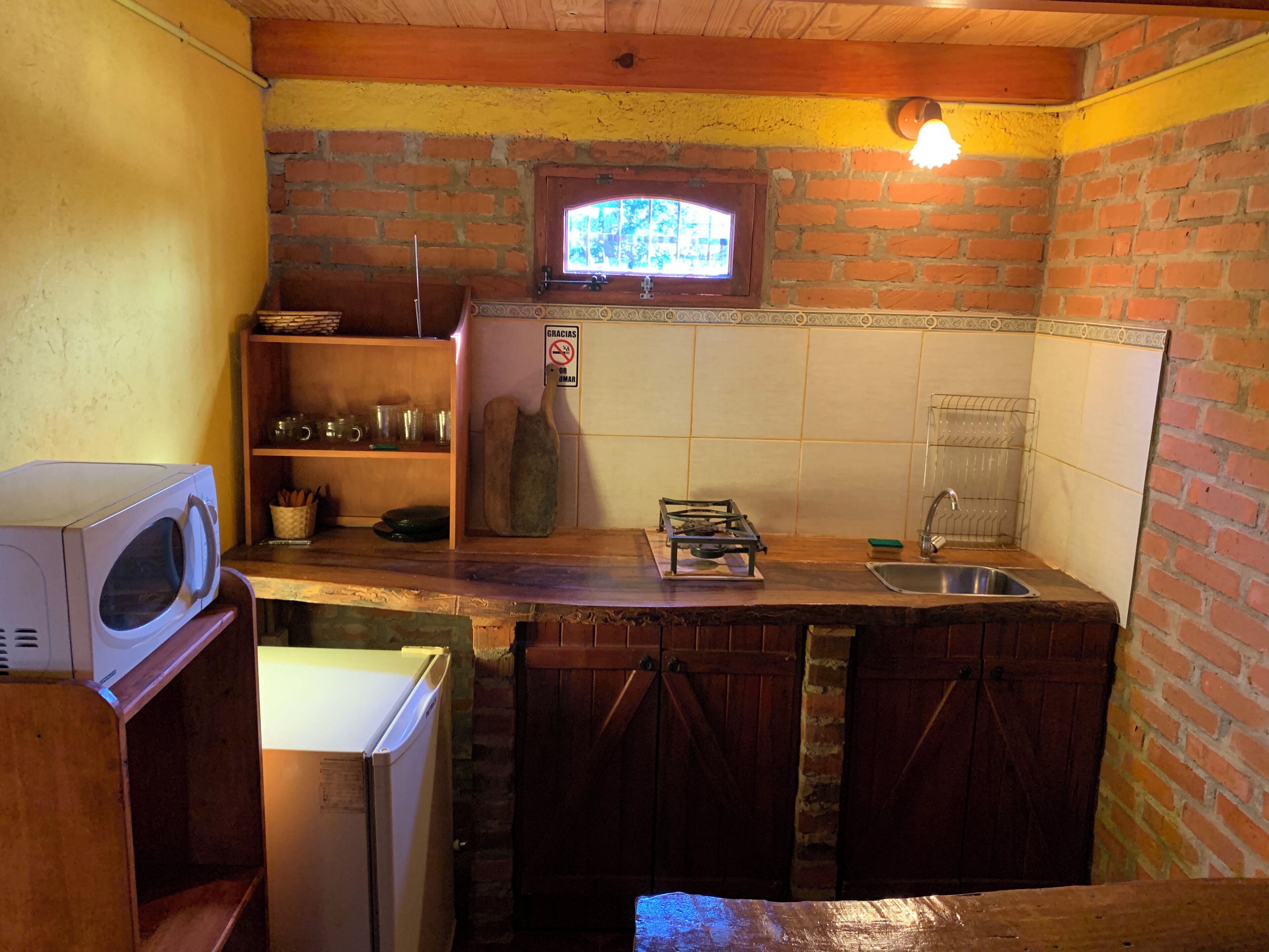 Fridge, microwave, cookware/dishes/utensils, dining tables