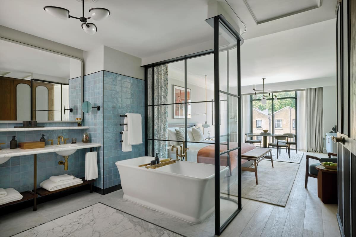 A modern bathroom with a freestanding bathtub, a glass shower enclosure, and a large mirror.