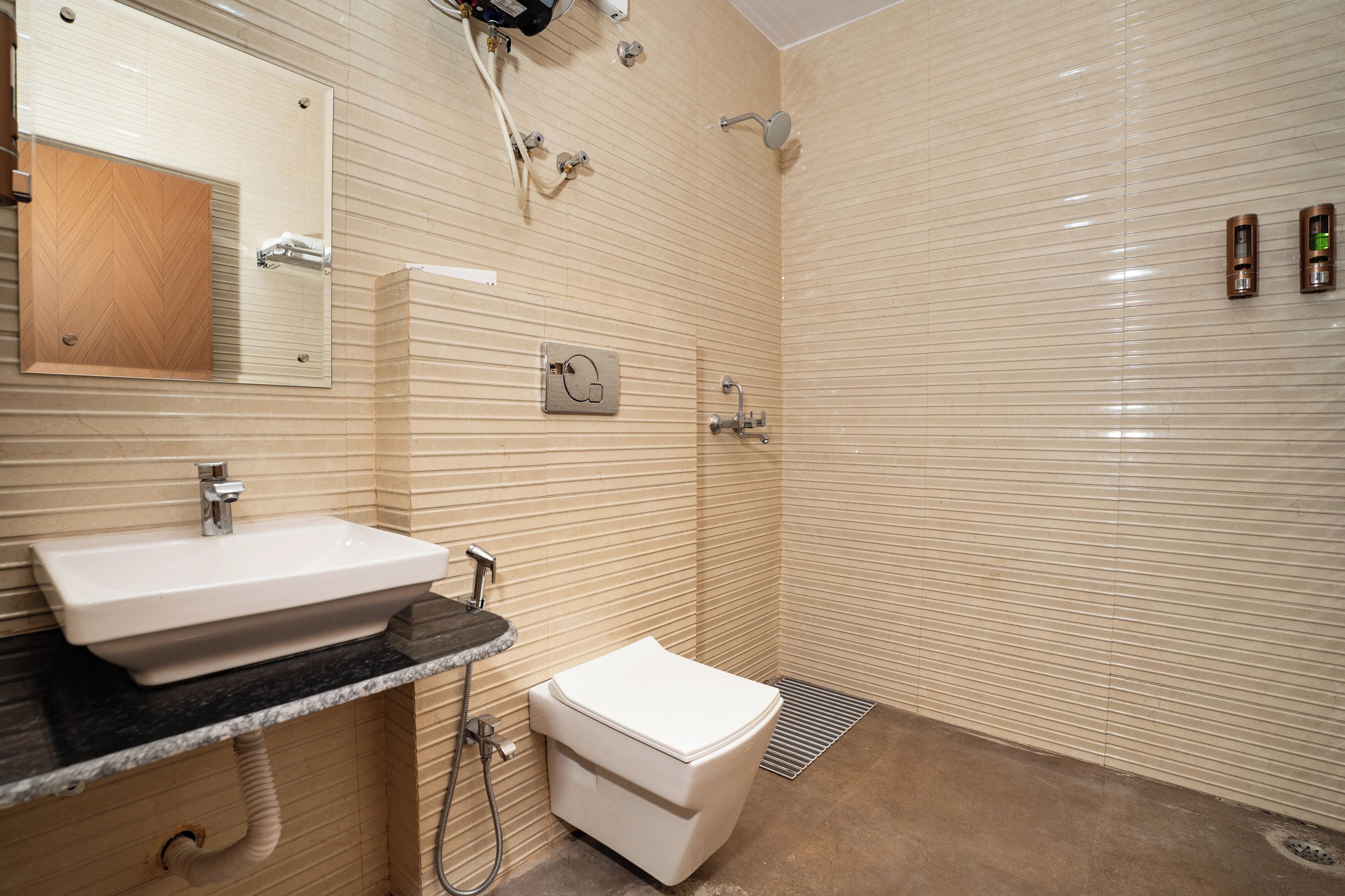 A bathroom with a sink, toilet, and shower area.