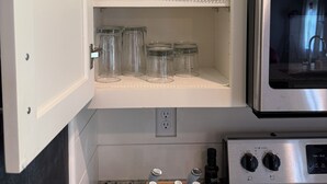 A kitchen with a built-in oven, a wine rack, and various kitchen utensils. - 3BR w/ Pool Table & Ping Pong - Near Snowden District, Landers Cnt & Outlet Mall (Southaven)