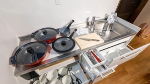 A compact kitchen with a sink, stove, and various utensils. - Oyado Satsuki Nara Gojo Shinmachi (Gojo)