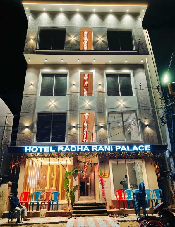 A hotel named "Hotel Radha Rani Palace" with a modern facade, multiple windows, and a well-lit entrance. - Hotel Radha Rani Palace (Puri)