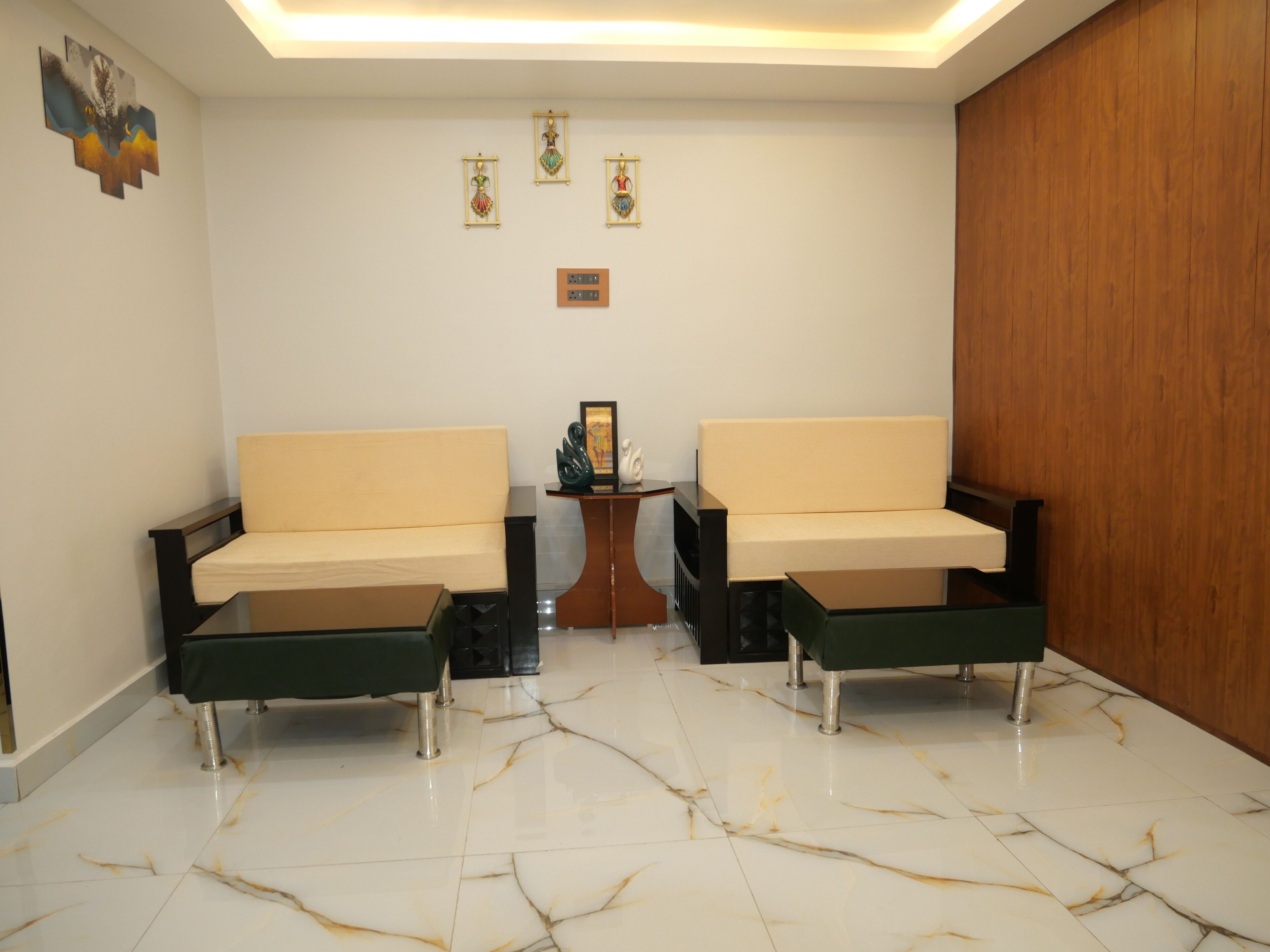 A room with two sofas, a small table, and a decorative wall piece.