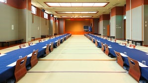 A conference room with a long table, chairs, and a television screen. - tabiyadoyobuko (Karatsu)