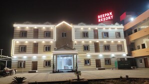 A multi-story building with a prominent neon sign reading "DEEPAK RESORT". - Deepak Resort (Chatabar)