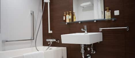 A modern bathroom with a white bathtub, a sink, and a shower.