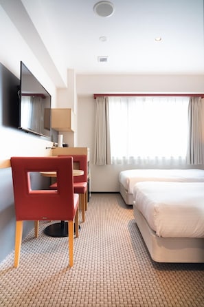 A hotel room with a bed, a desk with a chair, a television, and a window with curtains. - Chisun Standard Kyoto Horikawa Gojo (Kyoto)