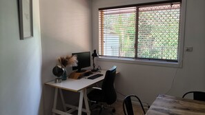 A workspace with a desk, computer, chair, and a window with blinds. - Relaxing country home half way between Gold Coast and Brisbane (Wolffdene)
