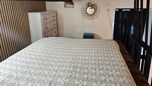A bedroom with a bed, a dresser, a mirror, and a window with curtains. - Duplex 15 min from train station, Montluçon historic center (Montluçon)