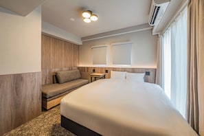A modern hotel room with a large bed, a built-in bench, a bedside table, and a window with curtains. - Apartment Hotel 11 Dotonbori 8 (Osaka)