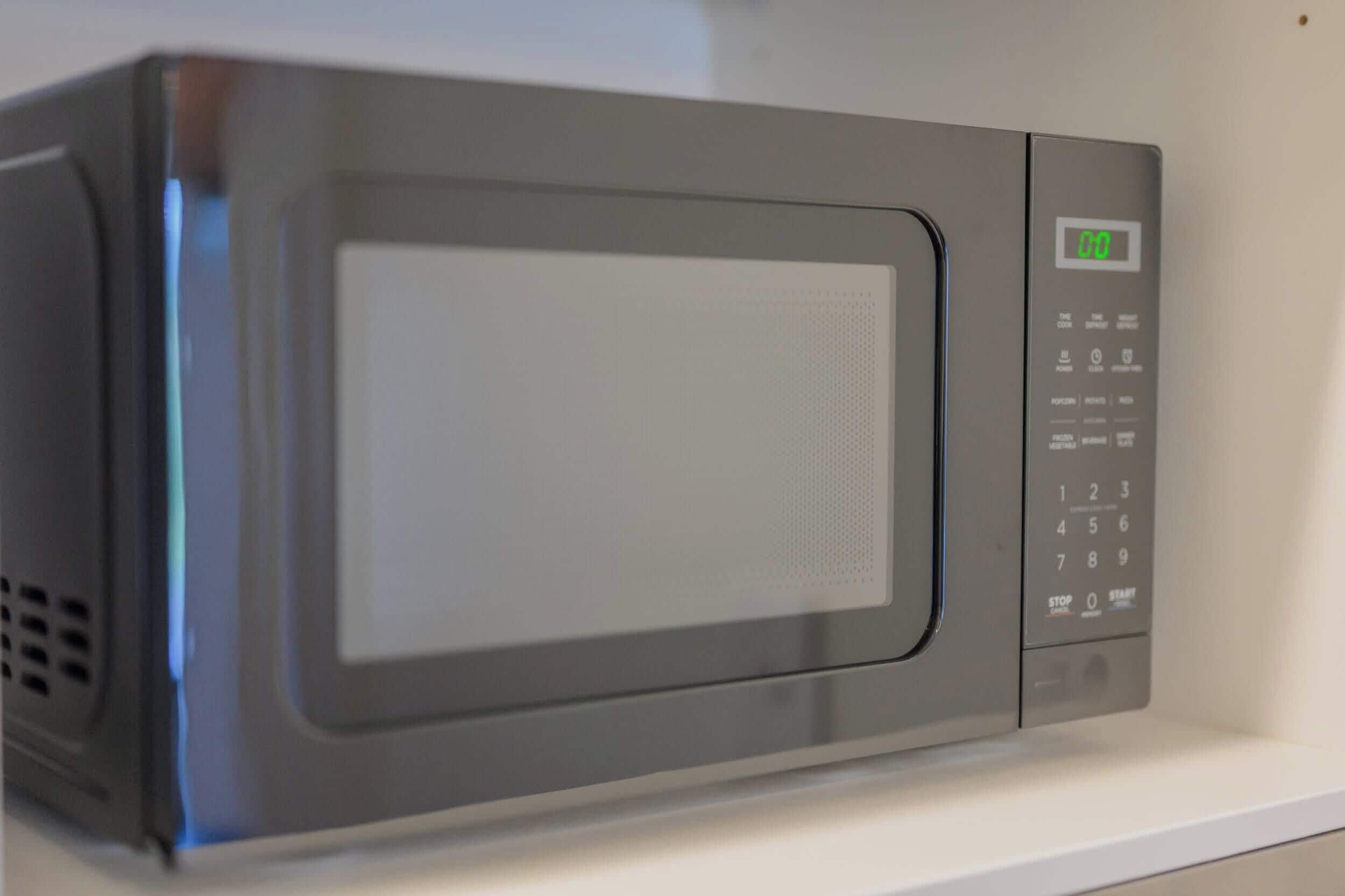 A microwave with a digital display and a numeric keypad.