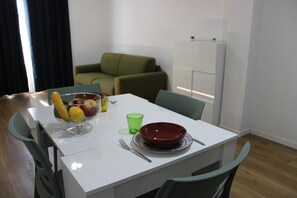 Apartment, Balcony, Courtyard View | Living area | 55-inch flat-screen TV with satellite channels, TV - Flamingo Houses (Quartu Sant'Elena)