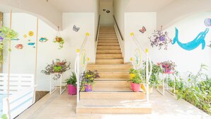 A wooden staircase with potted plants on either side, leading to an upper floor. - Villa Garden Island in Dalyan (Ortaca)