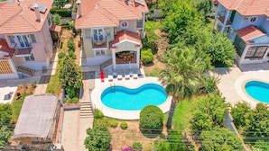 A residential area with multiple houses, a swimming pool, and a well-maintained garden. - Villa Rosetta in Oludeniz (Fethiye)