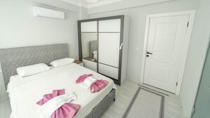 A bedroom with a bed, a wardrobe, a door, and an air conditioning unit. - Villa Maya in Ortaca (Ortaca)